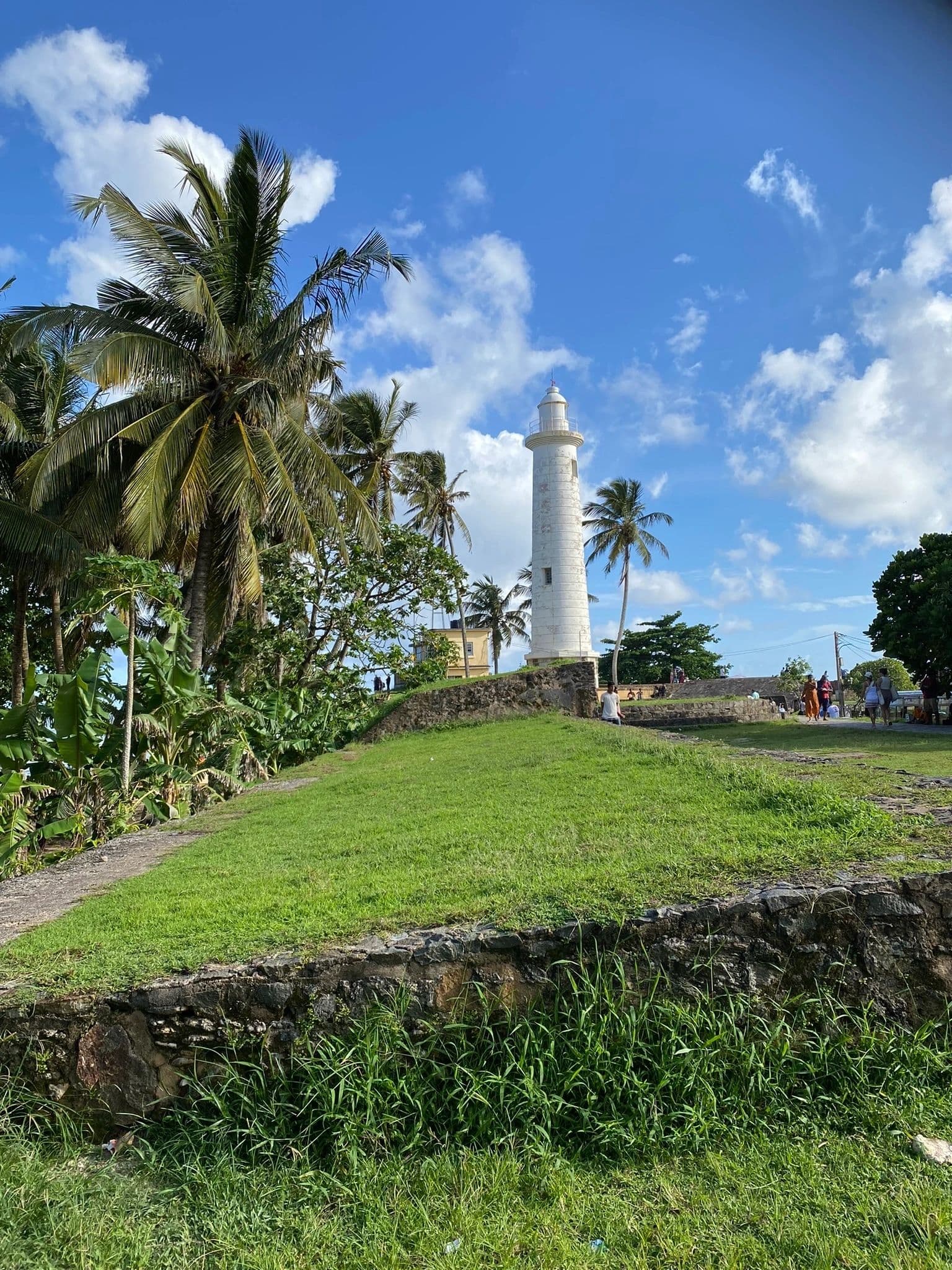 Galle Fort lighthouse surrounded by palm trees